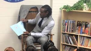 Brandon Carr reads to students at Dye Elementary School.